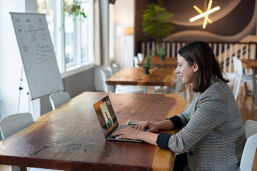 One researcher talking to another via videoconferencing on her laptop